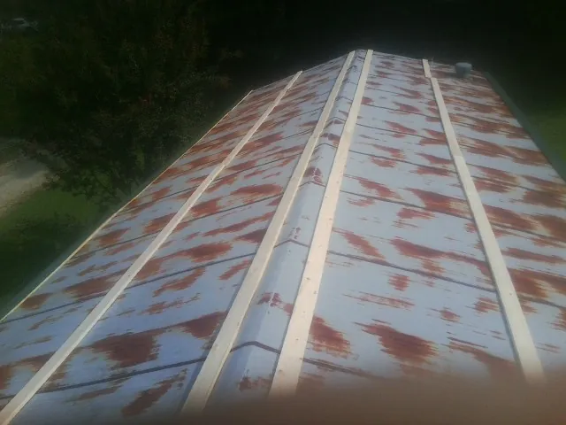 Rusted metal roof panels with new wood purlins before replacement — Storm Damage Roof Repair in Mayport by Roofing Brothers